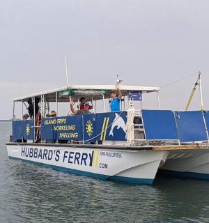 a blue and white ferry boat in the water