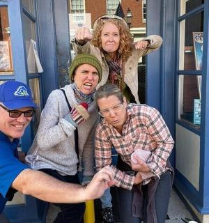 a group of people standing in a phone booth