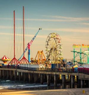 a pier with a amusement park and a ferris wheel