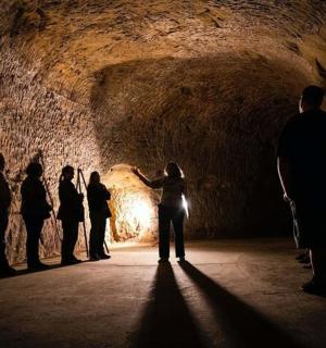 a group of people standing in a dark tunnel