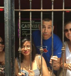 a group of people standing behind a gate