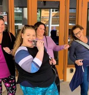 a group of women standing in a building