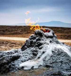 a pile of fire on a rock in the desert