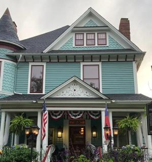 a blue house with a flag in front of it