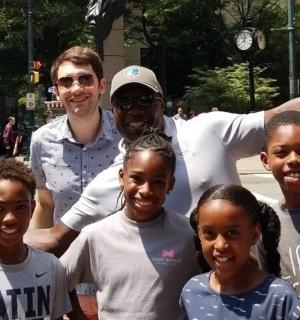 a man and a group of children posing for a picture