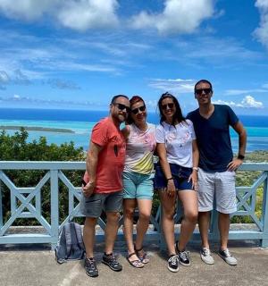 a group of people posing for a picture in front of the ocean