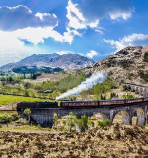 a train crossing a bridge over a river