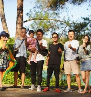 a group of people standing next to a tree