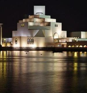 a building at night with water in front of it