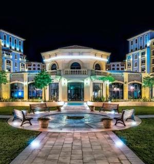a large building with benches in front of it at night