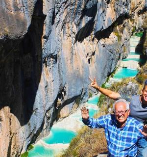 a group of people standing next to a river
