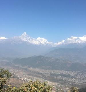 a view of a mountain range with snow capped mountains