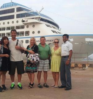 a group of people standing in front of a cruise ship