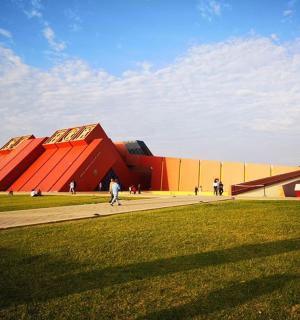 a large building with people walking in front of it