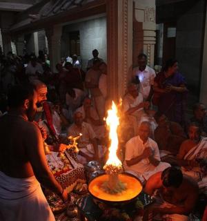 a man standing in front of a fire in a crowd