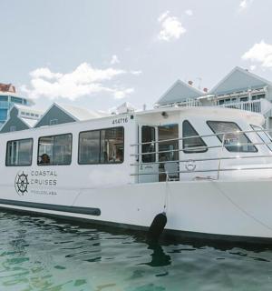 a white boat docked in the water next to houses