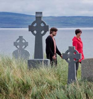 a man and a woman standing in front of a crosses