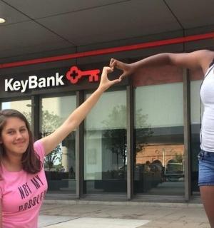 two girls are standing in front of a store