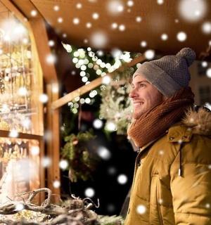 a woman standing in front of a christmas store