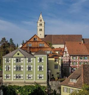 a group of buildings with a clock tower in the background