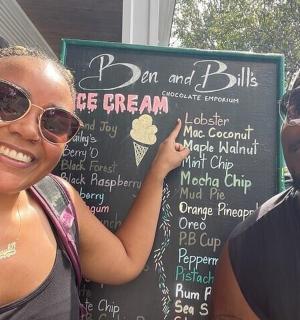 a man and a woman standing in front of a sign