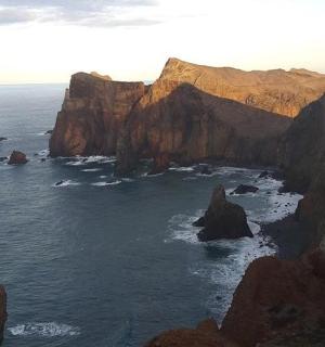 a view of the ocean with rocks in the water