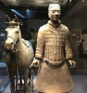 a statue of a man and a horse in a museum
