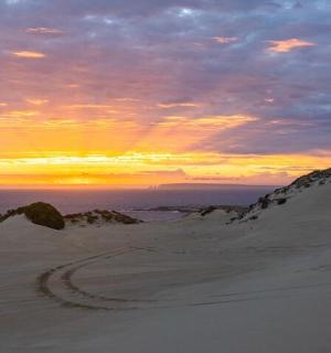 沙漠中,沙滩上留下脚印,夕阳西下