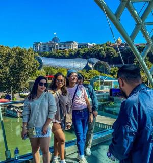 a group of people standing on a bridge