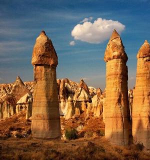a group of tall stone pillars in the desert