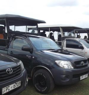 a row of parked vehicles parked in a field
