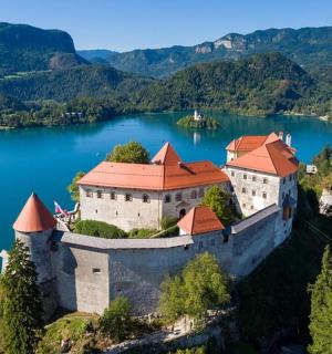 an island in the middle of a lake with a castle