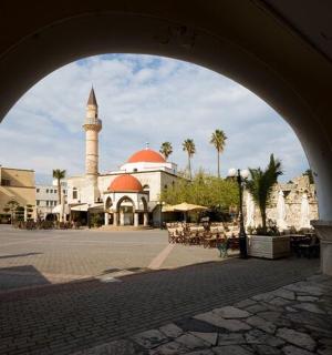 a mosque with a large building with a tall tower