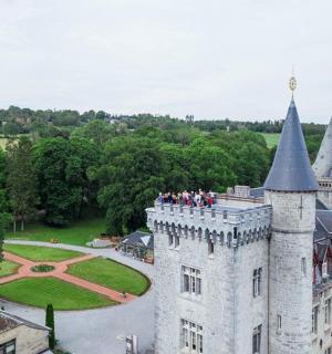 a group of people standing on top of a castle