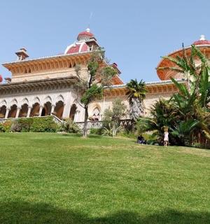 a large building with a grass field in front of it