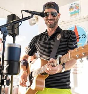 a man playing a guitar in a recording studio