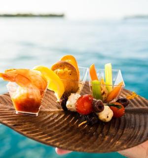 a person holding a plate of food on top