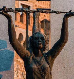 a statue of a woman holding a cross