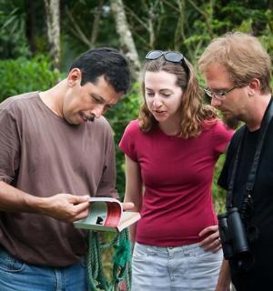 a group of three people looking at a laptop