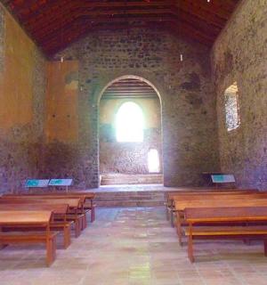a church with wooden pews in a room with a window