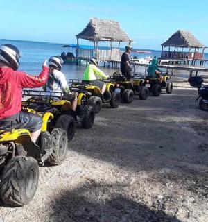 a group of people riding atvs on the beach