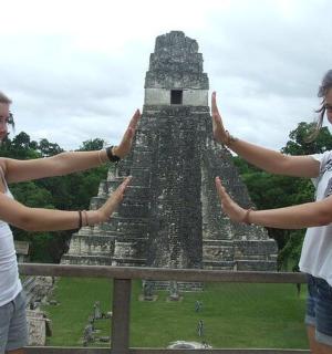 two young women standing in front of a temple