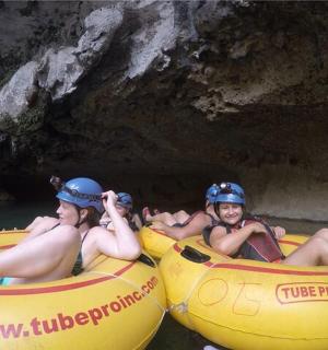 a group of people riding in tubes in the water