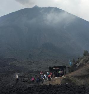 a group of people standing in front of a mountain