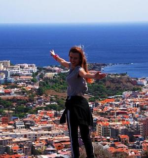 a woman standing on top of a city
