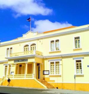 a yellow building with a flag on top of it