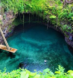 a swing in a pool of water in a cave