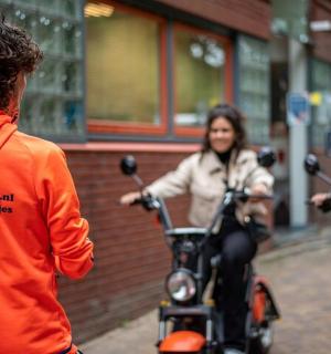 a group of people riding motorcycles down a street