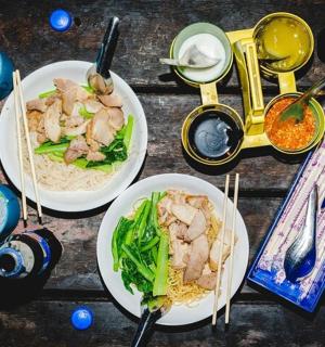 two plates of food on a wooden table