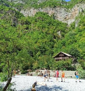 a group of people on a beach near a mountain